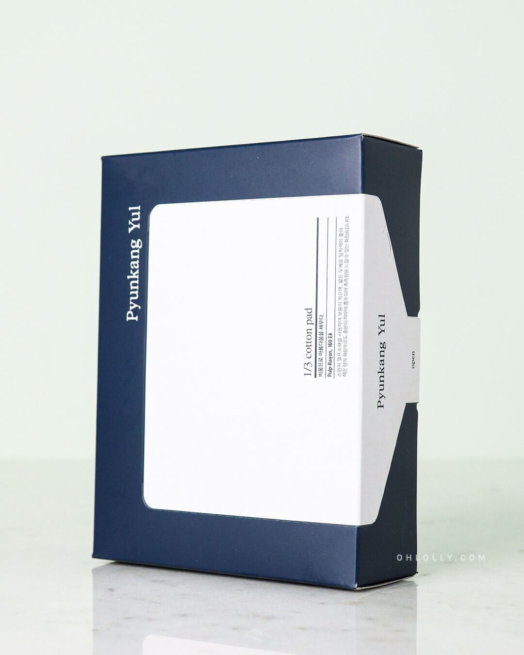 Studio shot of the Pyunkang Yul 1/3 Cotton Pads box, standing upright. The box is a deep, matte blue with a rectangular white label on the front, emphasizing the '1/3 cotton pad' name and the brand's minimalist packaging.