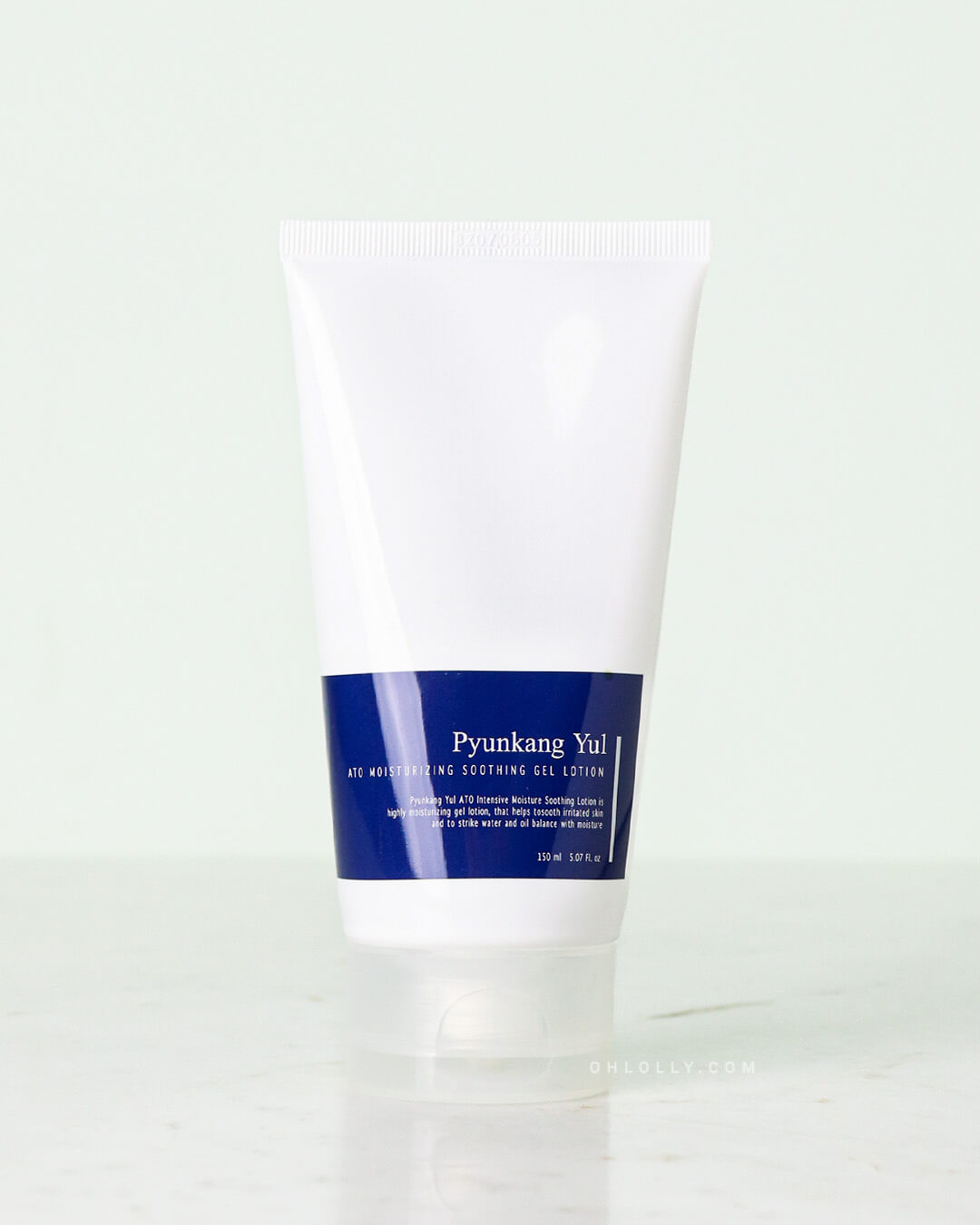 Front-on product shot of the Pyunkang Yul ATO Moisturizing Soothing Gel Lotion tube. The white tube has a distinctive deep blue label and stands upright on a pale surface, emphasizing its simple, clean packaging.