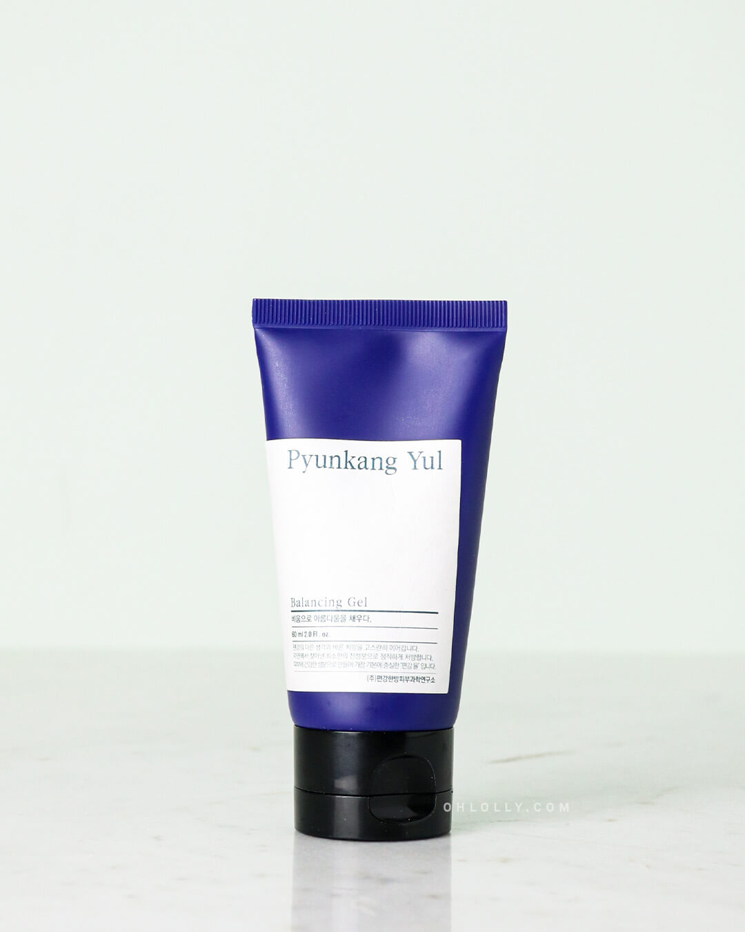 Front-on studio shot of the Pyunkang Yul Balancing Gel tube (60ml size). The dark blue tube with the white label stands upright on a pale surface, showcasing the product in its smaller, travel-friendly squeeze tube packaging.