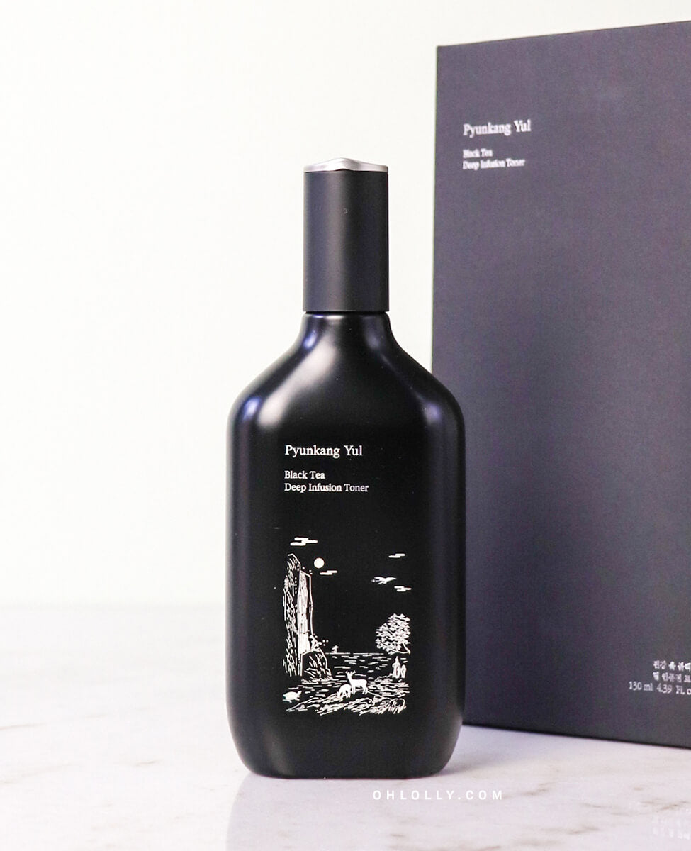 Front-on studio shot of the Pyunkang Yul Black Tea Deep Infusion Toner bottle standing next to its black outer box. The image emphasizes the product's elegant packaging and focus on deep hydration with fermented black tea.