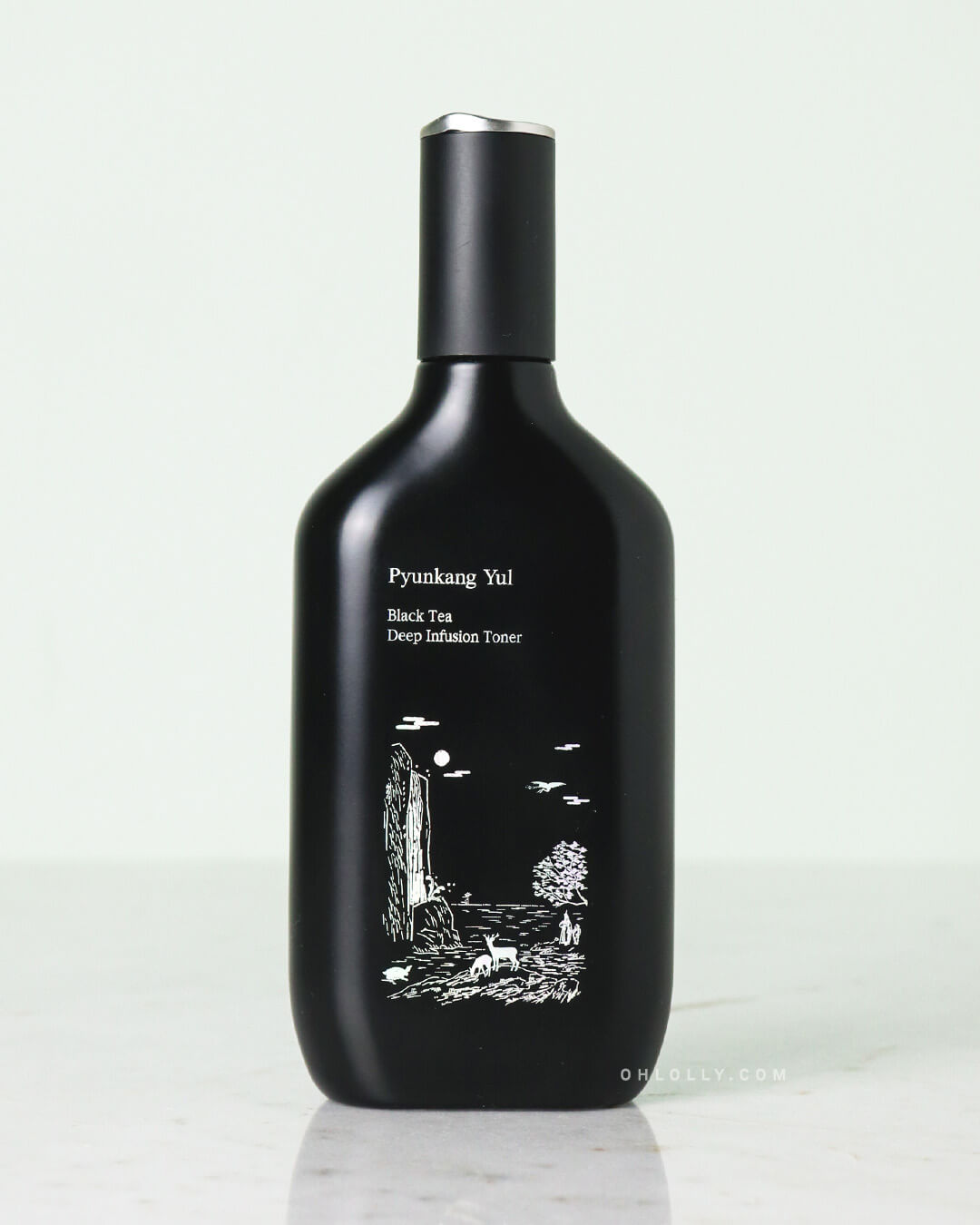 Front-on studio shot of the Pyunkang Yul Black Tea Deep Infusion Toner bottle, highlighting the unique white illustration of a waterfall and landscape. The bottle stands on a pale surface, emphasizing its nourishing, gel-like texture.