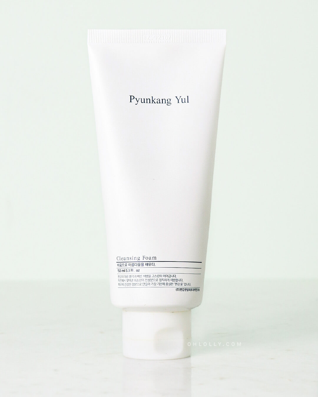 Front-on studio shot of the white Pyunkang Yul Cleansing Foam tube, highlighting its simple, minimalist design and the cleanser's ability to act as a vacuum cleaner for pores with its rich, sticky texture.