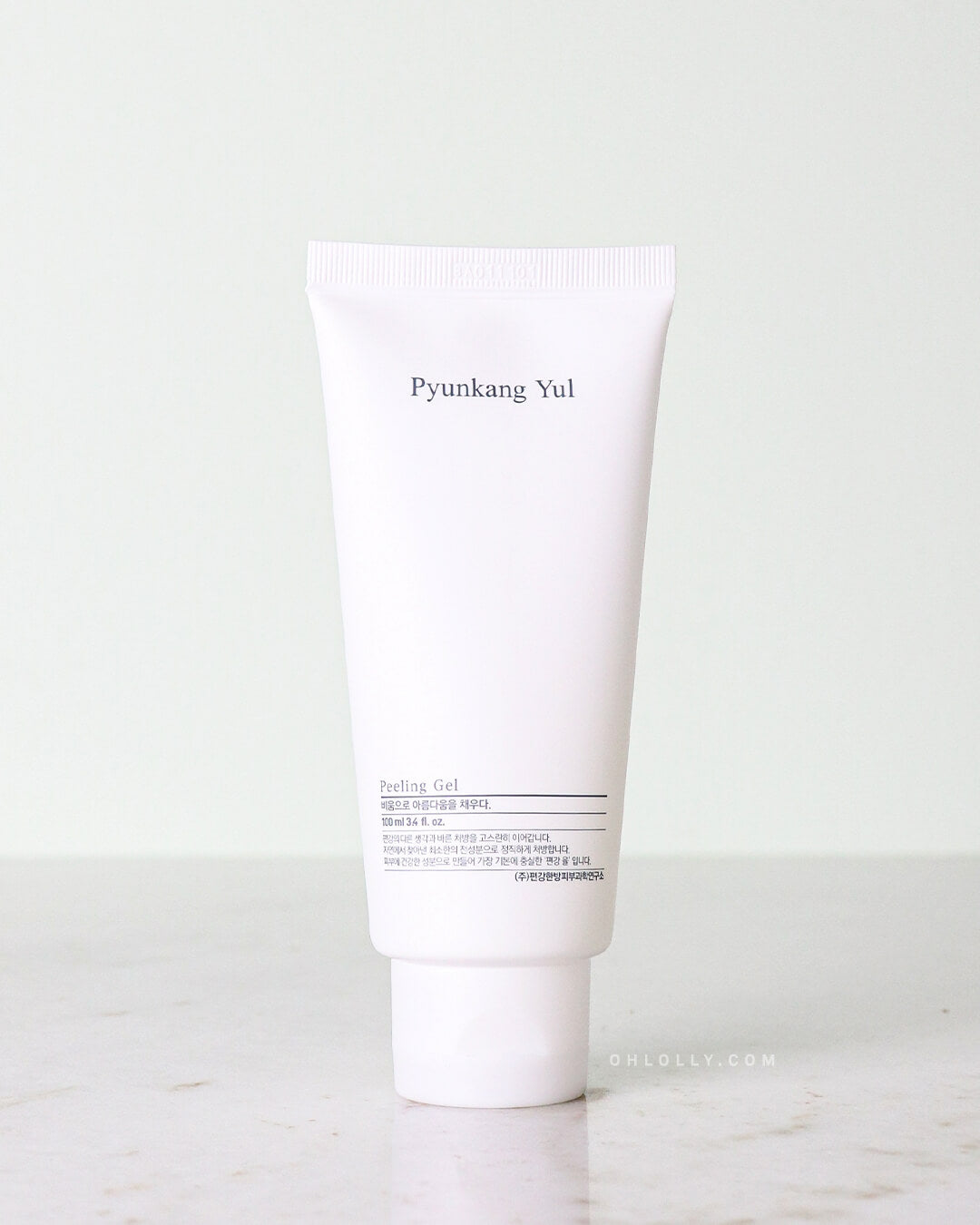 Studio shot of the Pyunkang Yul Peeling Gel. The white tube with a white cap is standing upright, clearly displaying the product name on its simple label against a pale background.