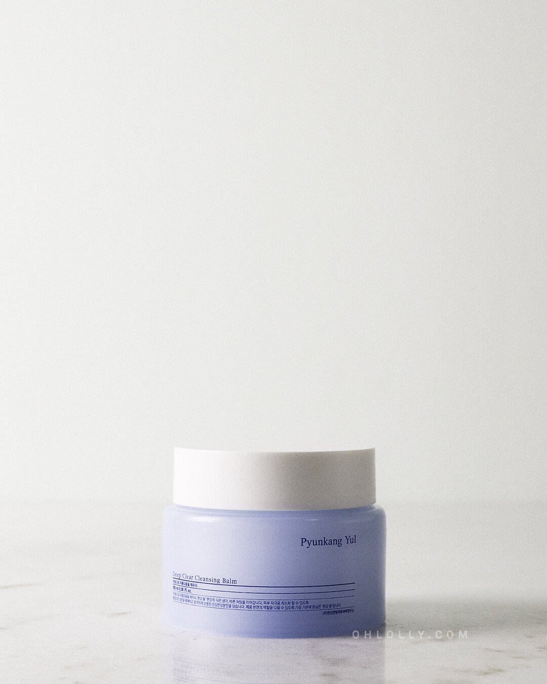 Close-up studio shot of the Pyunkang Yul Deep Clear Cleansing Balm jar, showing the light blue jar and white lid against a light background.