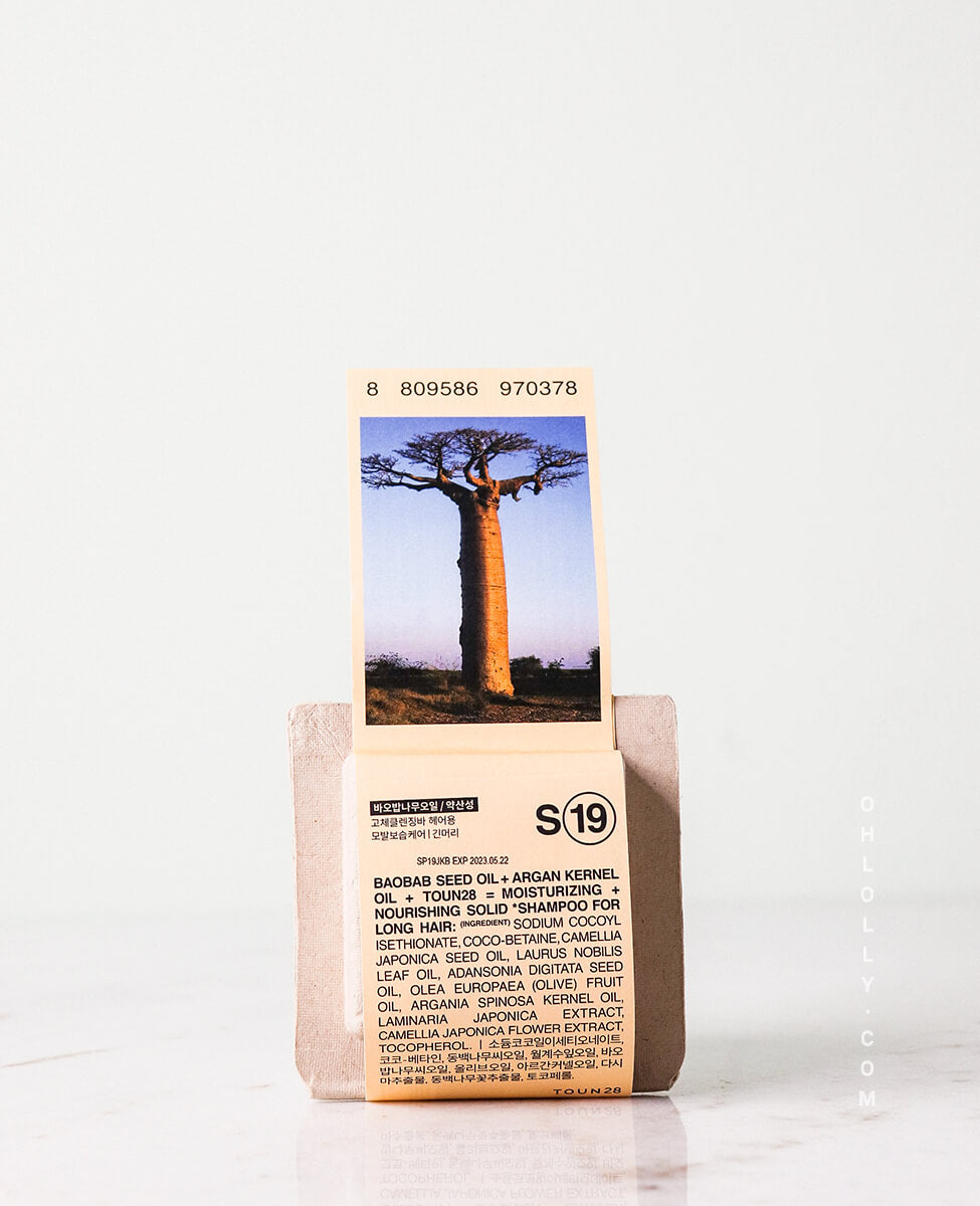 Toun28 S19 beige shampoo bar with baobab and argan oil on plain background