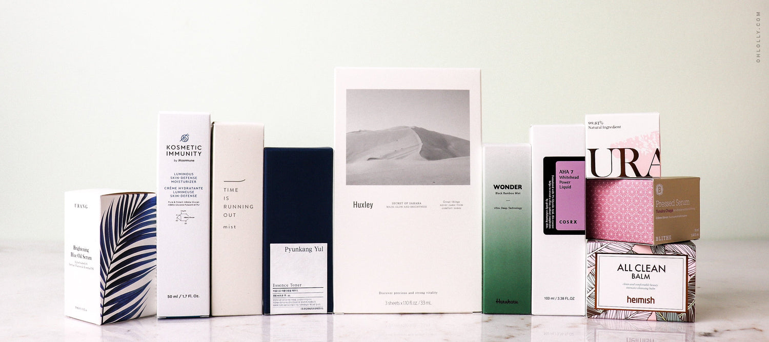 A row of K-Beauty product boxes: Heimish All Clean Balm, Huxley mask, Haruharu Wonder, and URANG serum. Skincare haul.
