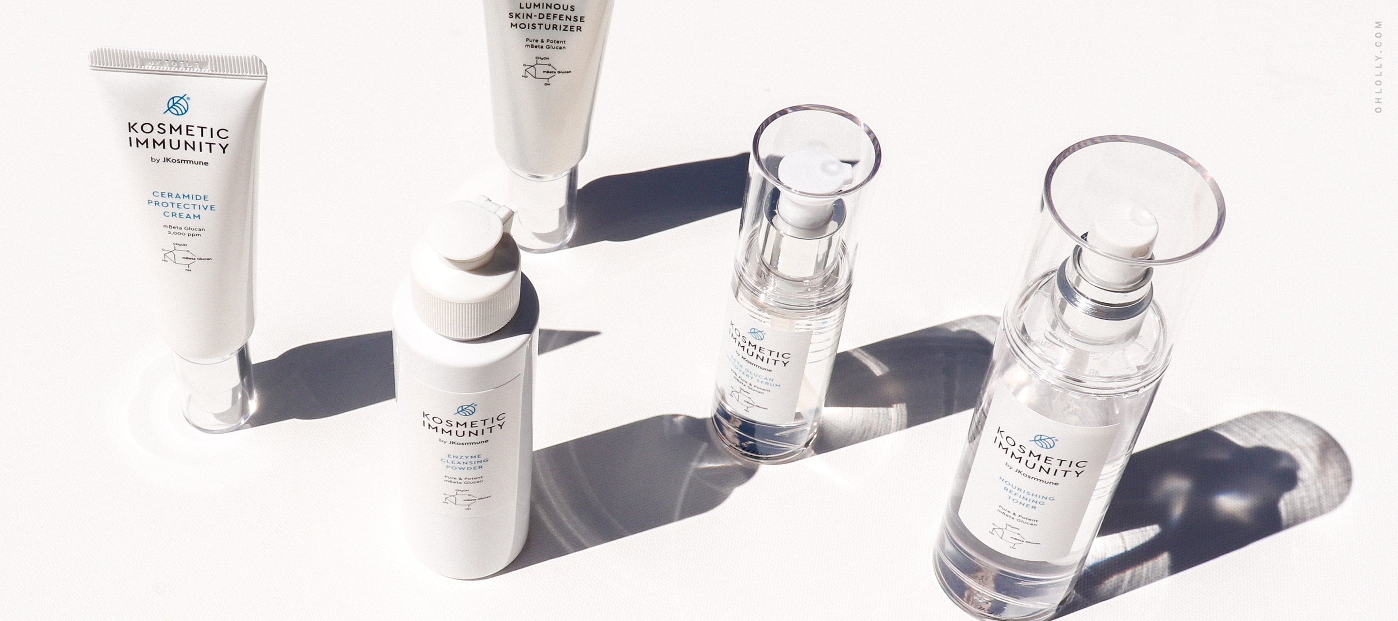  A flat lay image showing four different products from the Kosmetic Immunity skincare line.