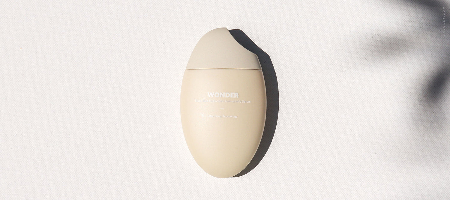 Single Haruharu Wonder Black Rice cream bottle, egg-shaped, resting on a white surface with shadows.