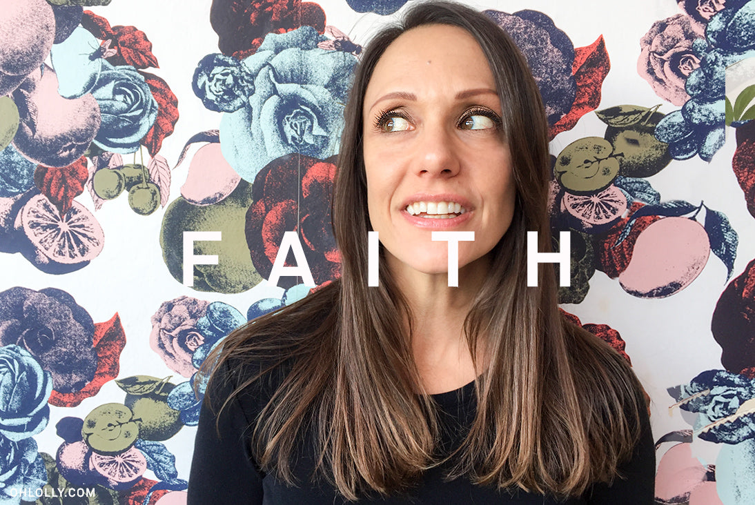  A close-up photo of a smiling woman with dark hair against a floral background.