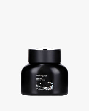 A rounded black jar with white landscape illustrations and a silver-accented lid.