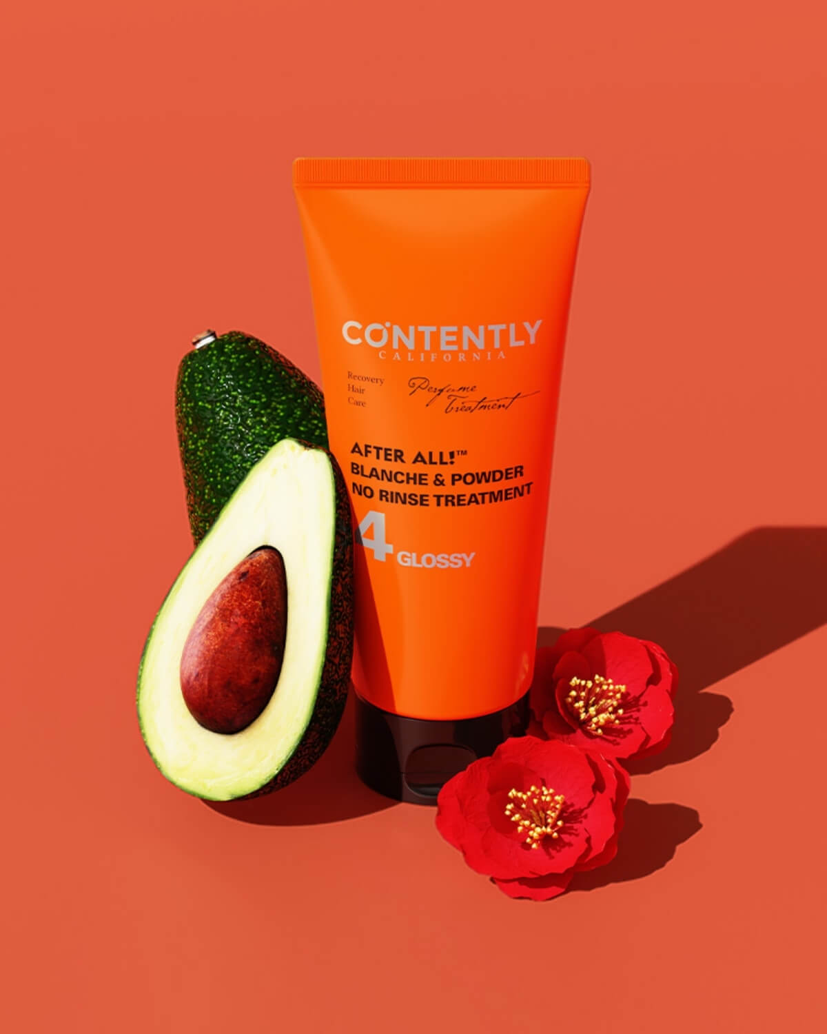 An orange tube of CONTENTLY CALIFORNIA's "After All! Blanche & Powder No Rinse Treatment" is positioned upright next to a whole and a halved avocado, with two red camellia flowers in the foreground, all on a bright orange background.