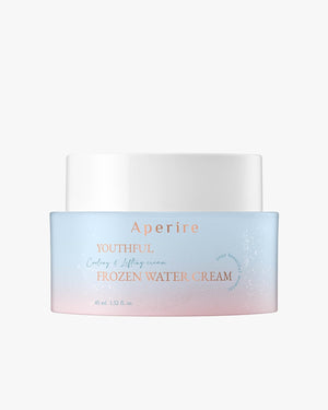 A centered product shot of the Aperire Youthful Frozen Water Cream jar. The jar has a white lid and a body with a frosted, light blue-to-pink ombre design, set against a neutral background.