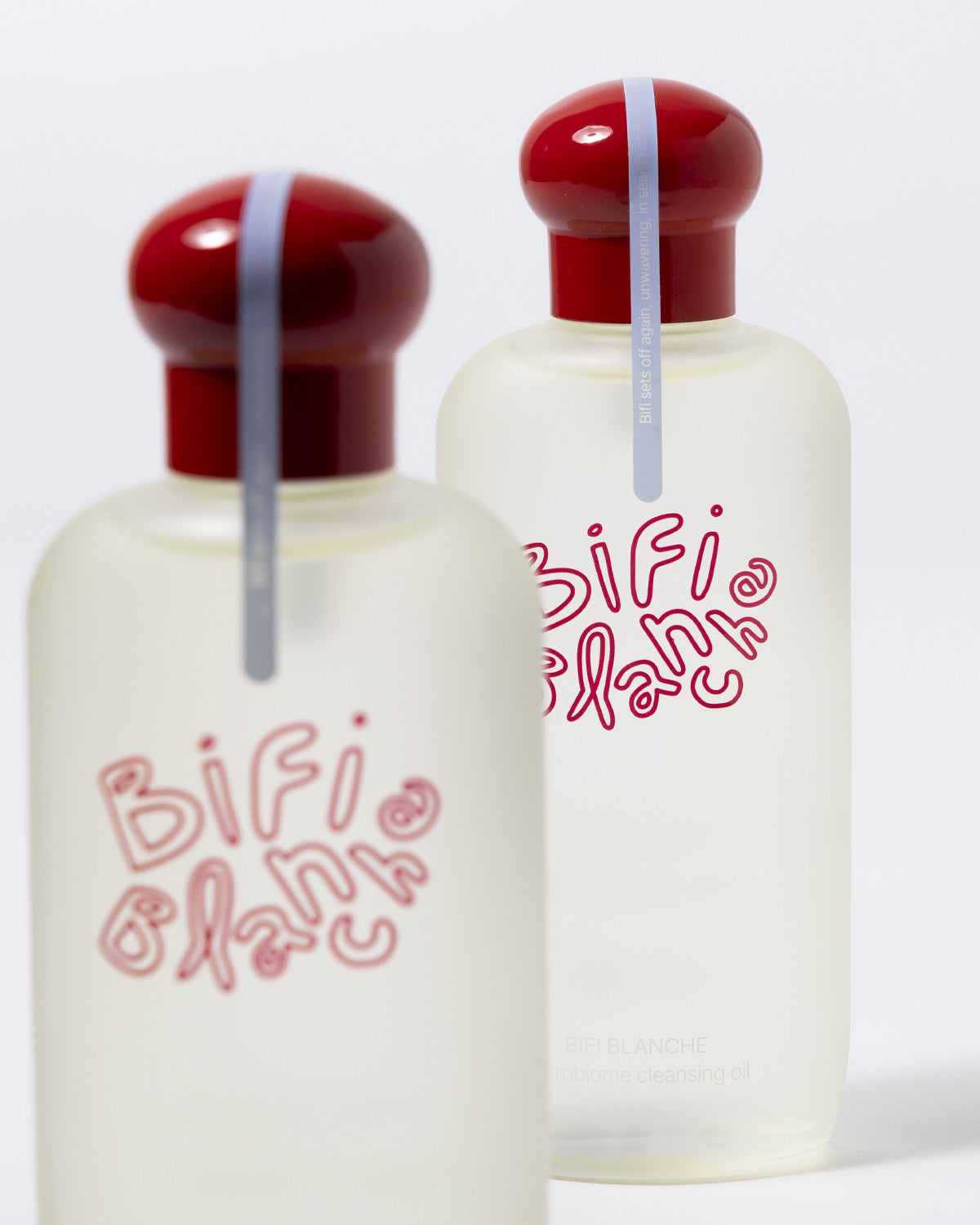 Close-up of two Bifi Blanche Microbiome Cleansing Oil bottles with one in soft focus.