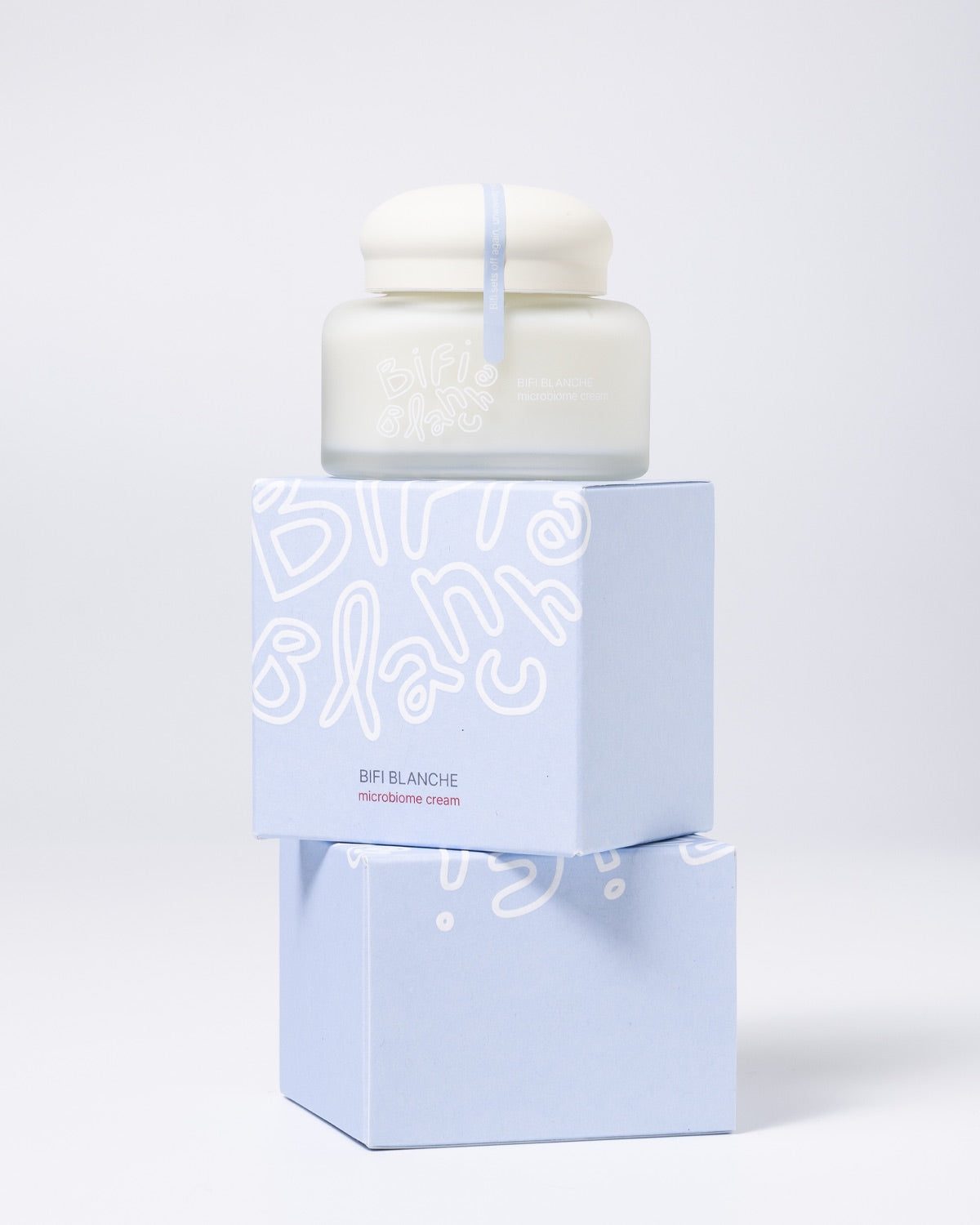 Bifi Blanche Microbiome Moisture Cream jar stacked on top of two light blue product packaging boxes.