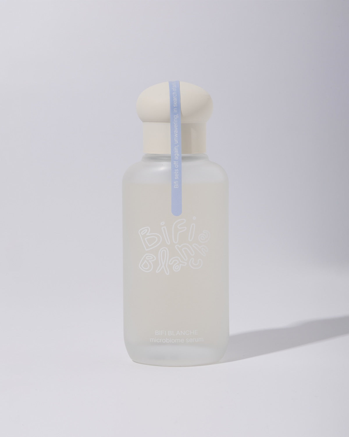 Front view of a frosted glass bottle of Bifi Blanche Microbiome Serum on a white backdrop.