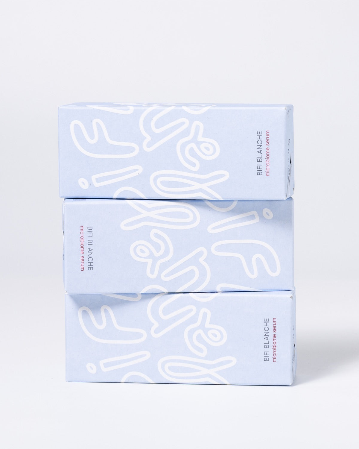 Three light blue Bifi Blanche Microbiome Serum boxes stacked horizontally on top of each other.