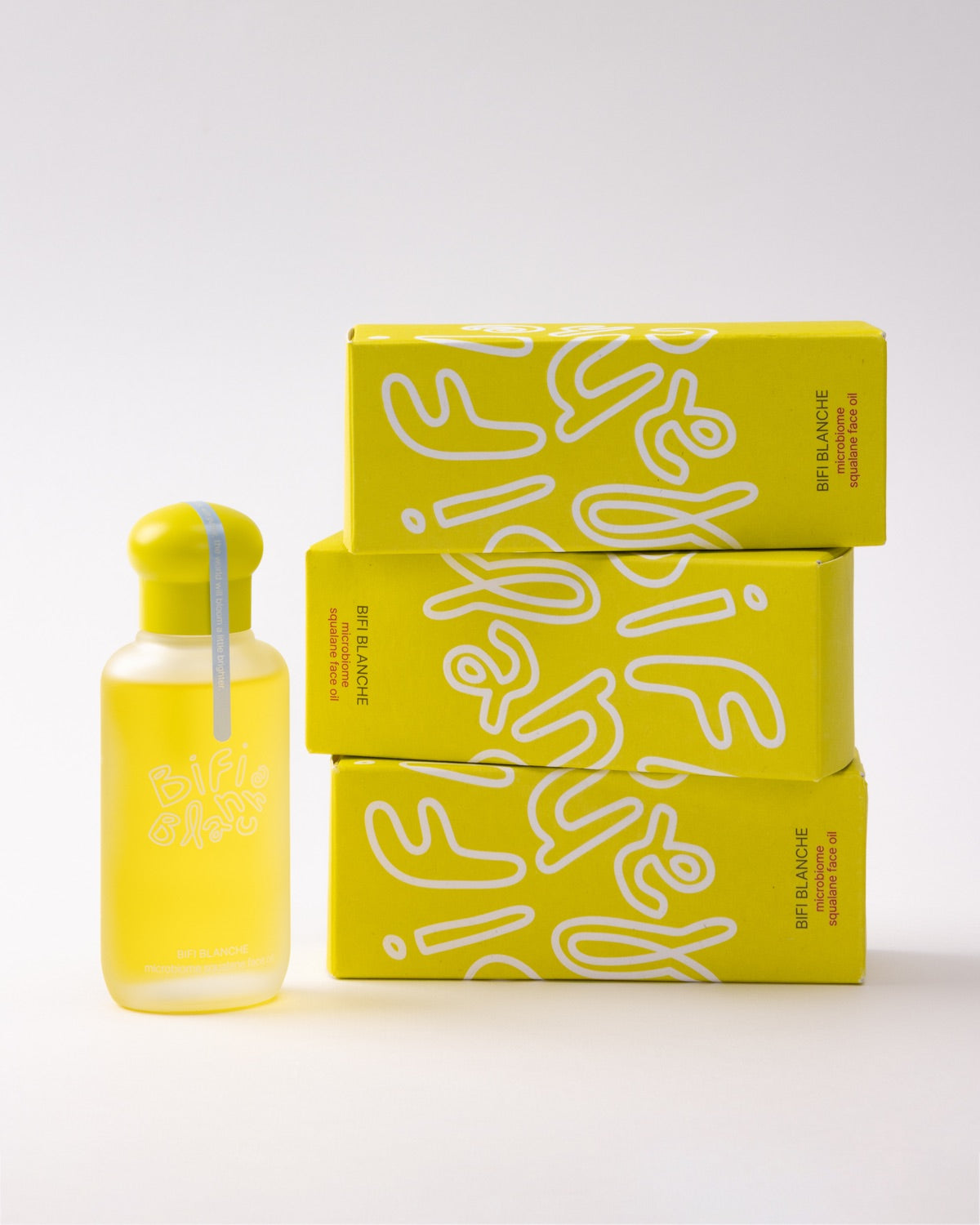 A single bottle of Bifi Blanche Microbiome Squalane Face Oil next to a stack of three yellow packaging boxes.