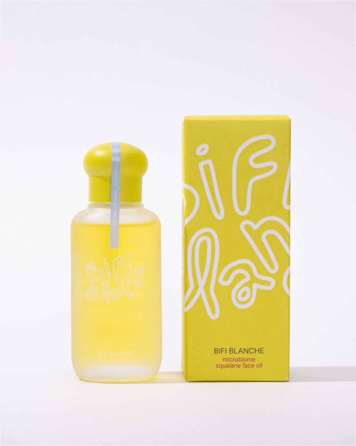 Bifi Blanche Microbiome Squalane Face Oil bottle standing vertically next to its yellow product packaging box.