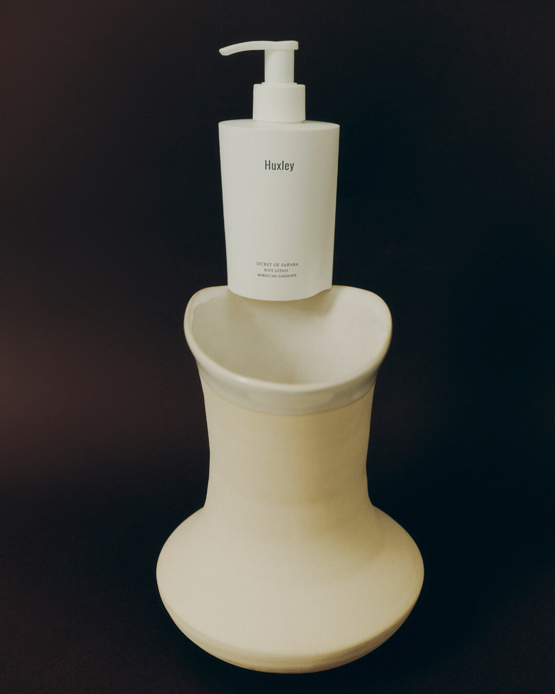 Hydrating white body lotion being gently rubbed onto skin for deep moisturization.