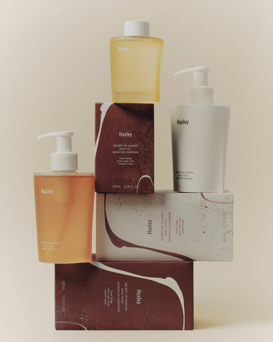Collection of Huxley Moroccan Gardener body care products and packaging boxes stacked together.