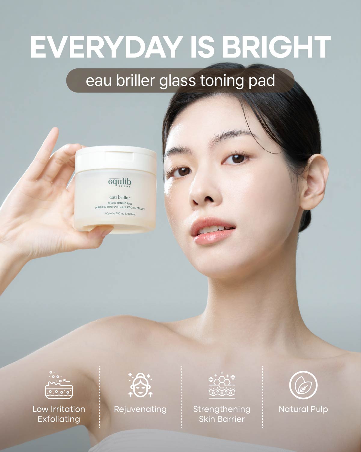 Model holding Equilib Eau Briller Glass Toning Pad. Benefits: Low irritation exfoliation and skin barrier support.