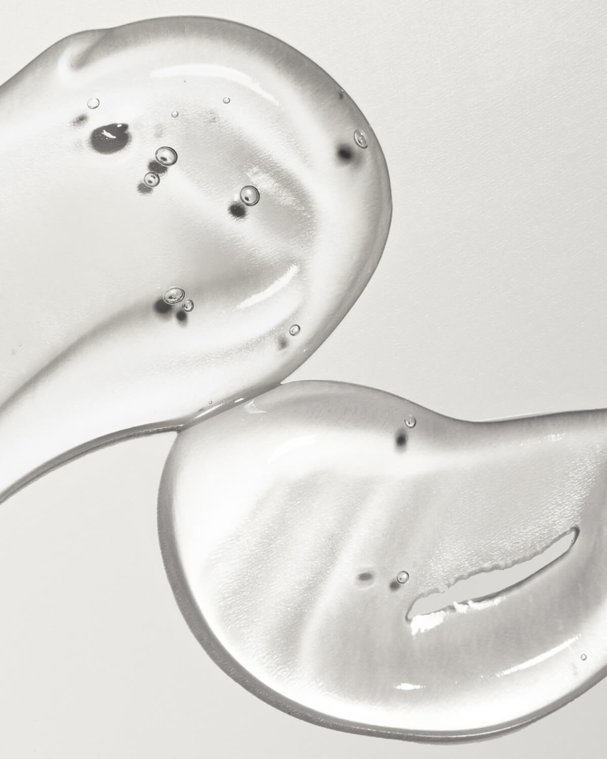 Clear, hydrating gel serum texture swatches showing lightweight viscosity and air bubbles.