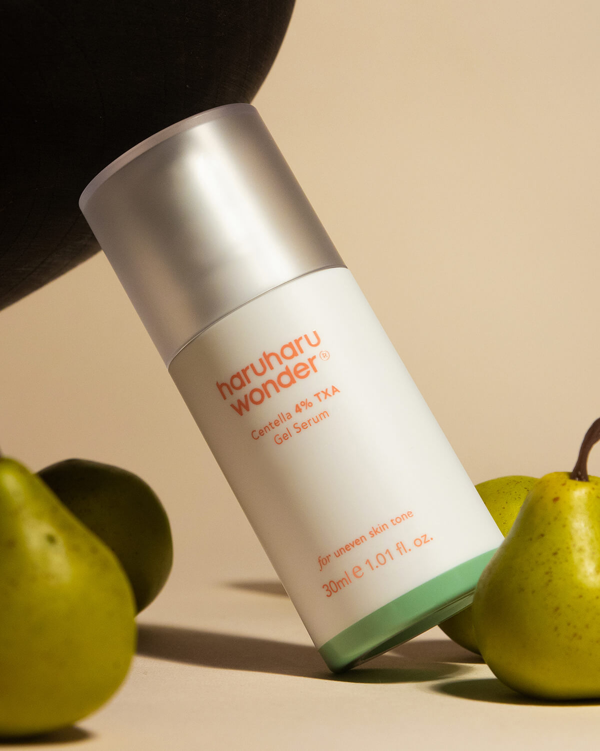 Haruharu Wonder Centella 4% TXA Gel Serum bottle surrounded by fresh pears.