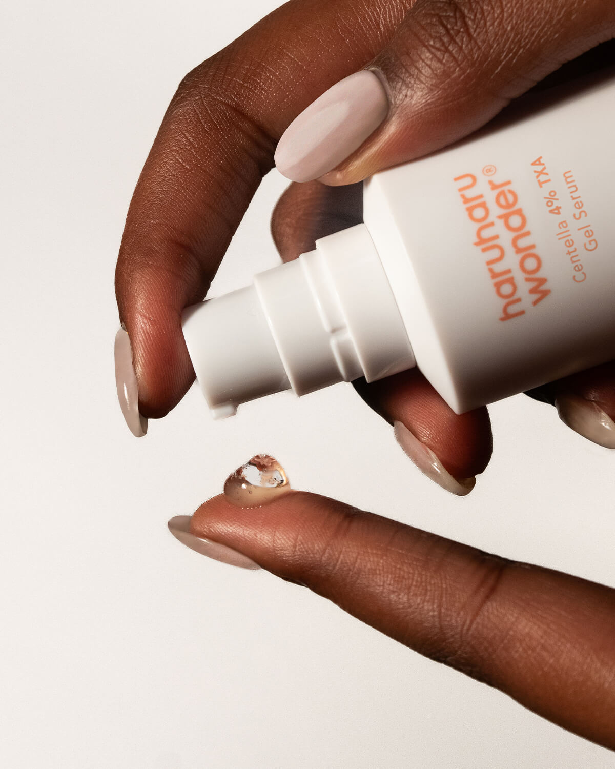Close-up of Haruharu Wonder TXA Gel Serum being pumped onto a fingertip.
