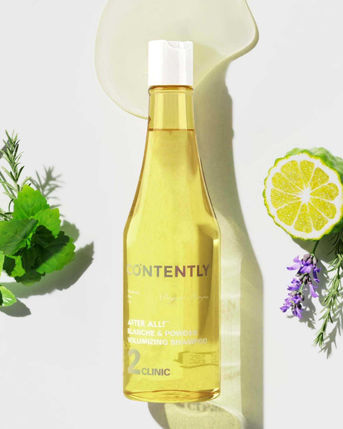 Flat lay of Contently shampoo bottle surrounded by fresh bergamot, lavender flowers, mint leaves, and liquid gel.