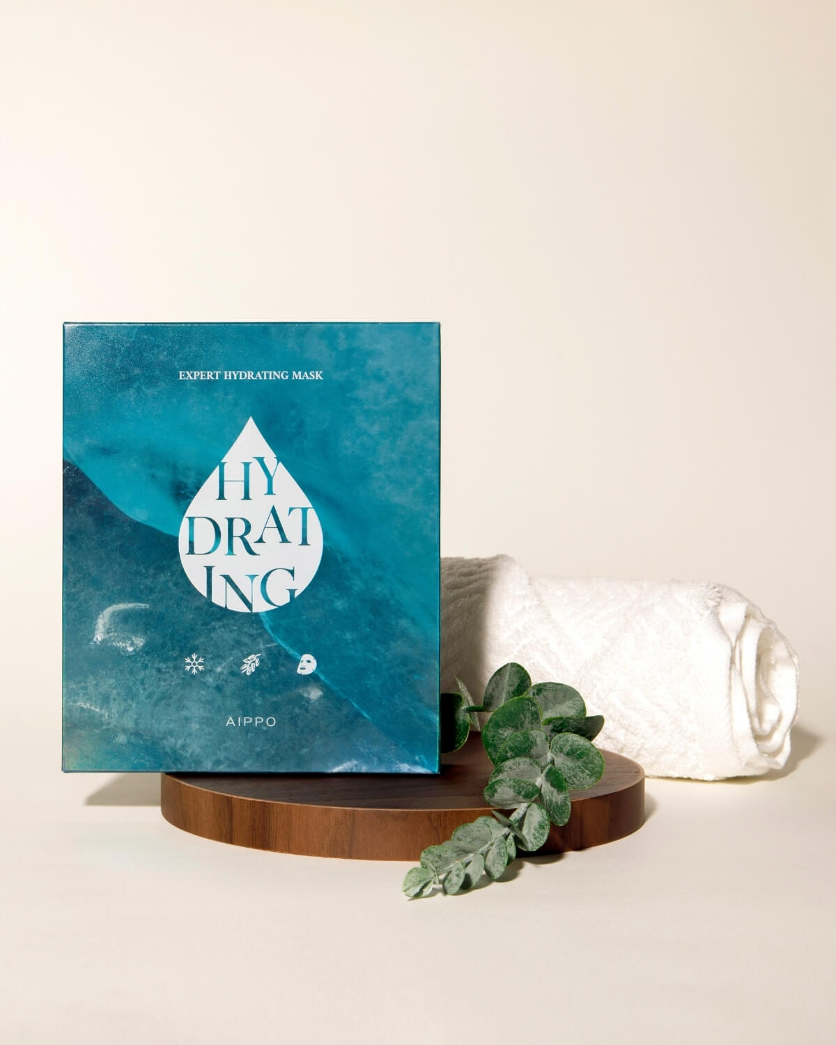 AIPPO Expert Hydrating Mask box on a wooden stand with a towel. K-beauty product for expert hydrating skin care.