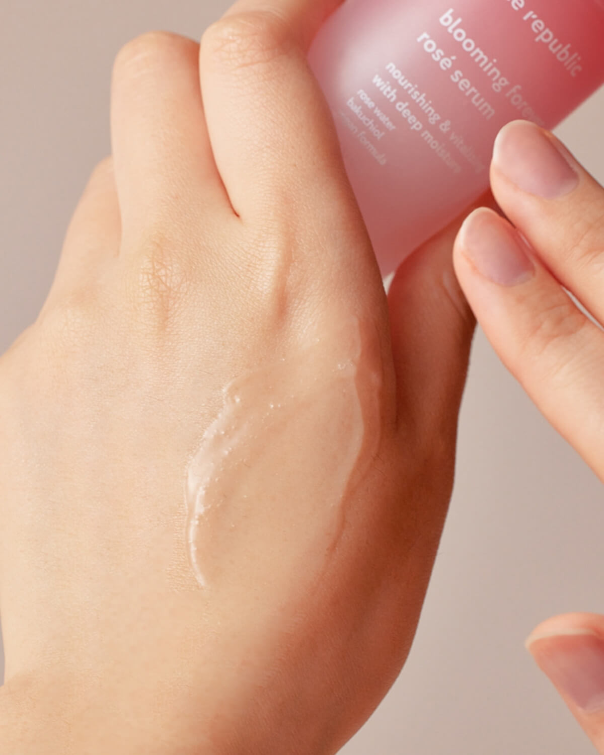 Clear lightweight serum texture being applied to the back of a hand.