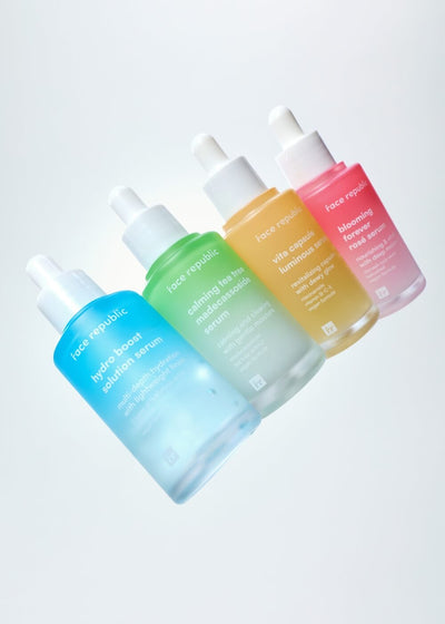 Set of colorful skincare bottles on a light gray background