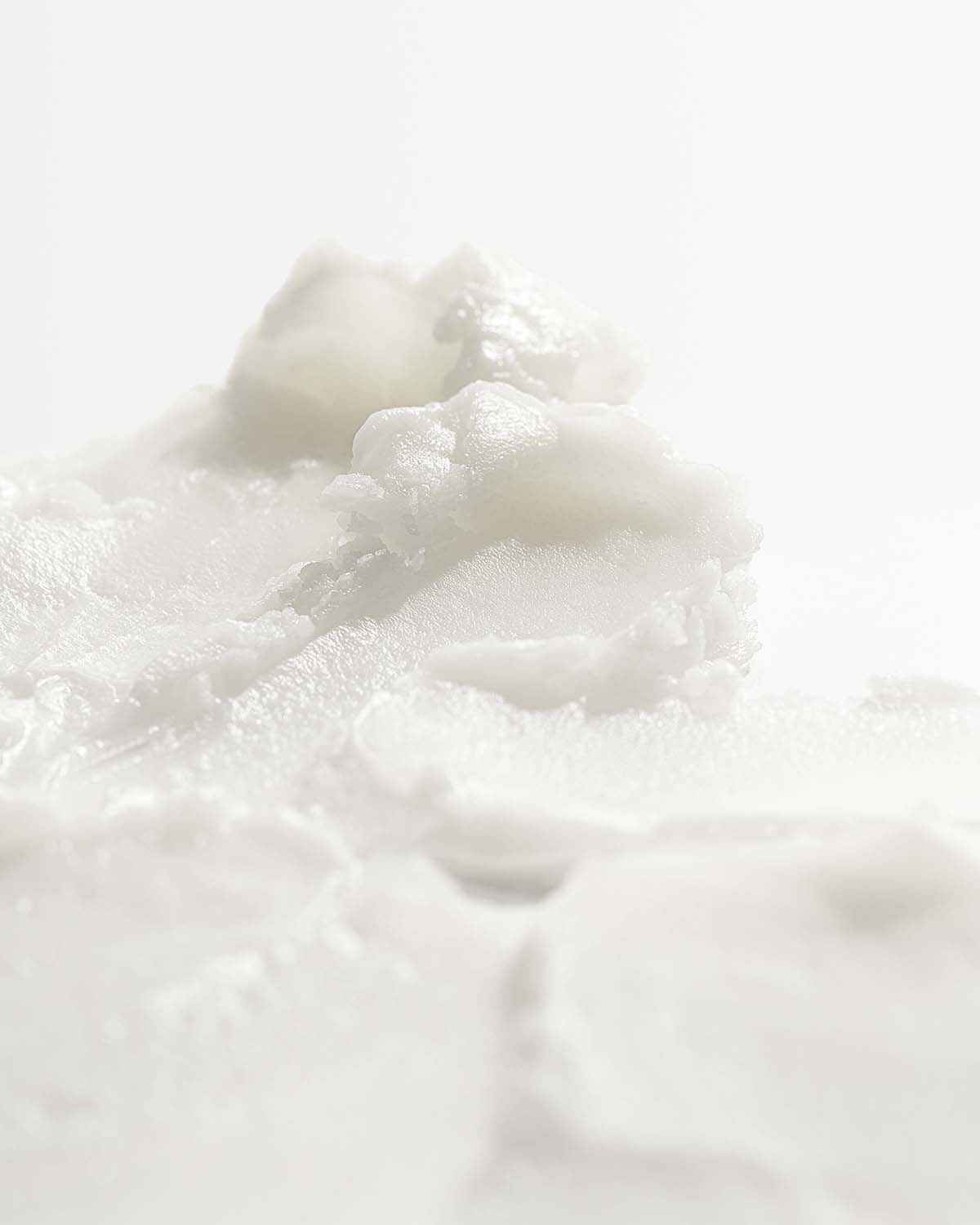 Extreme close-up of the thick, creamy white texture of Purito From Green Avocado Cleansing Balm.