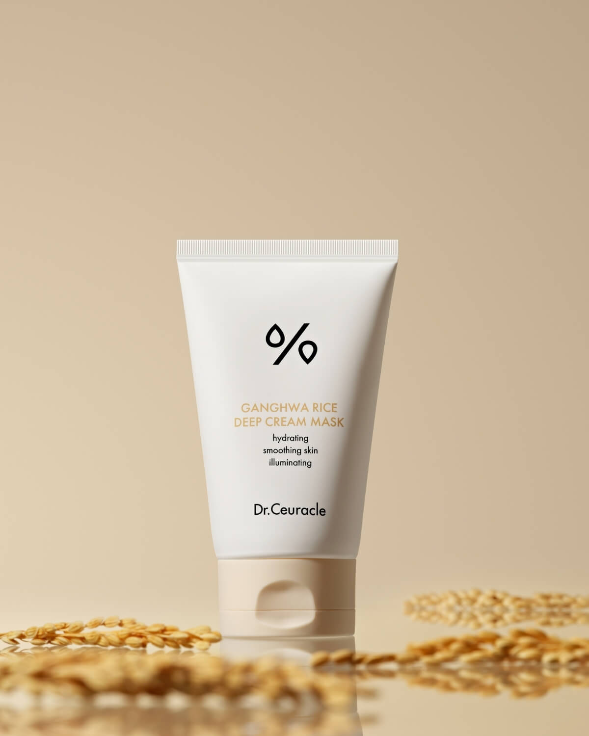 Dr. Ceuracle Ganghwa Rice Deep Cream Mask standing on a reflective beige surface near rice stalks.