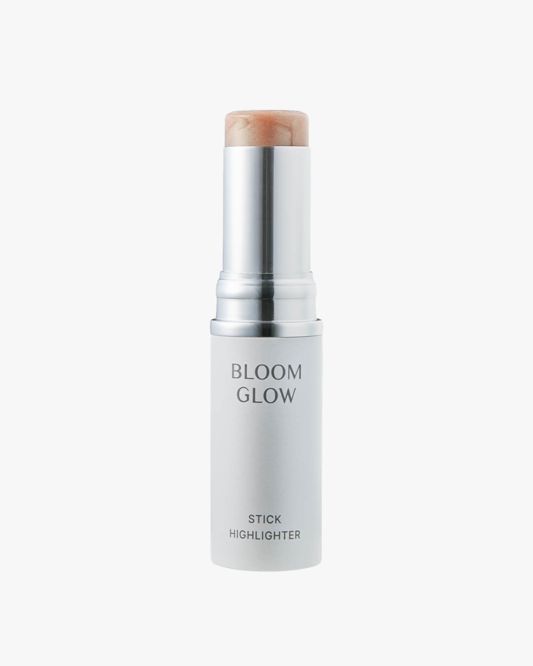 White tube of Koy Bloom Glow Stick Highlighter with a metallic silver casing showing the shimmery champagne balm.