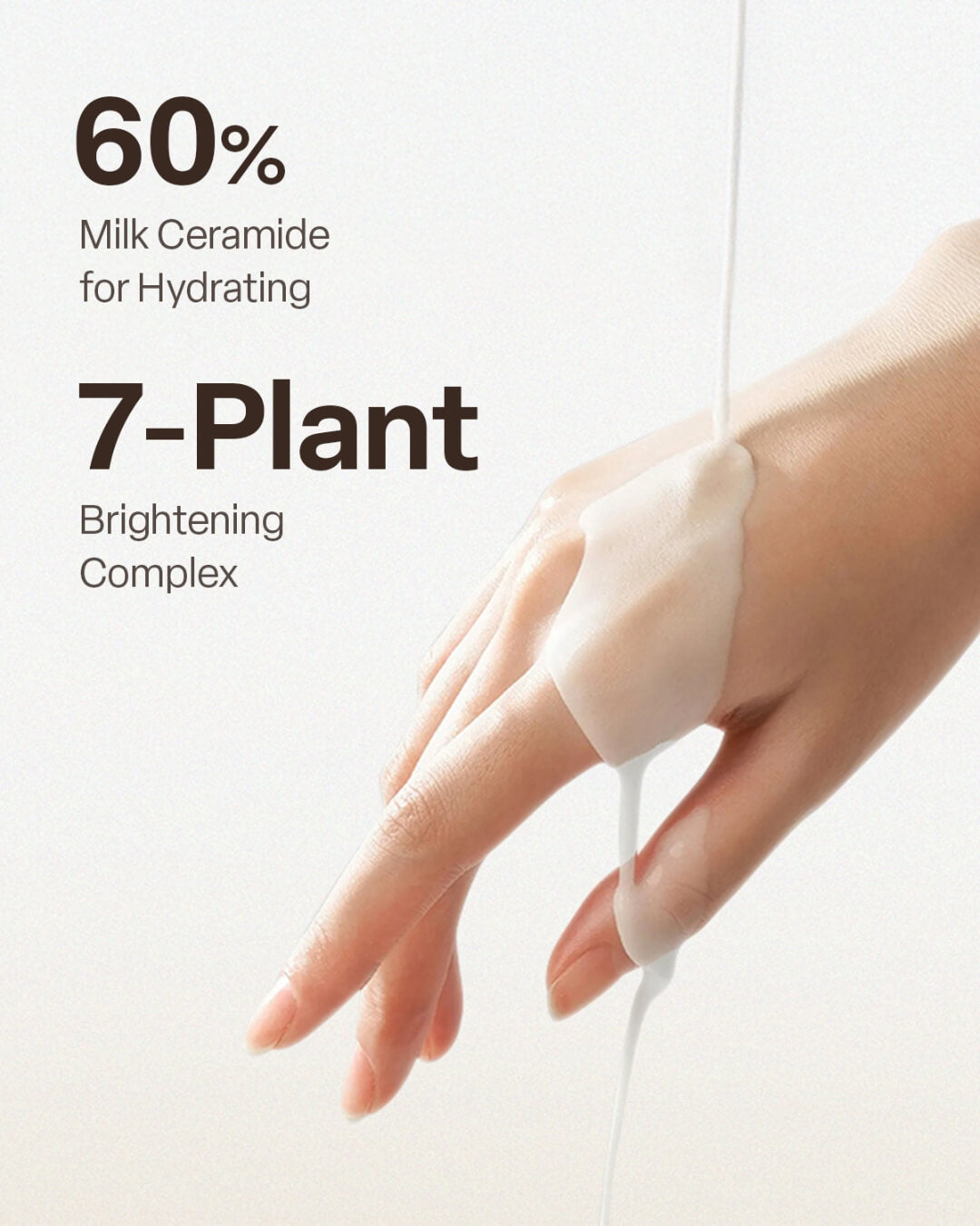 Milky white liquid toner pouring onto a woman's hand to showcase hydration and brightening ingredients.