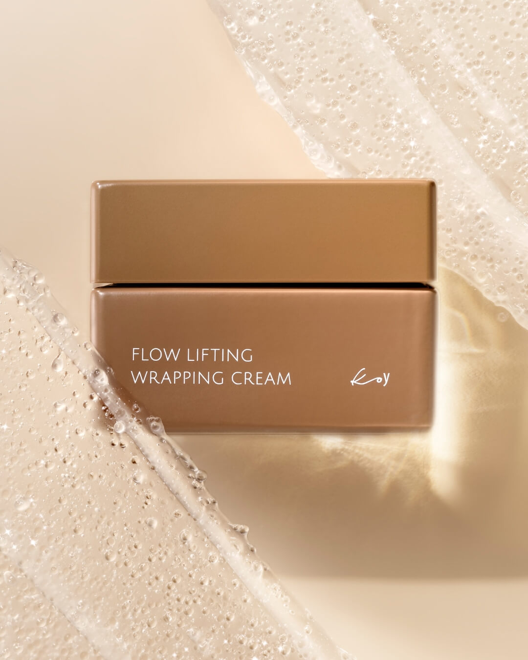 Koy Flow Lifting Wrapping Cream jar surrounded by clear, hydrating gel textures on a beige background.