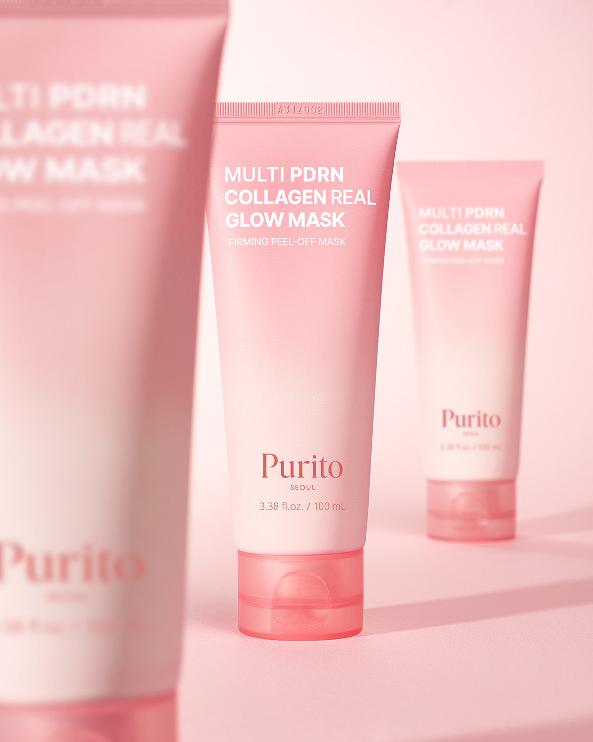 Three tubes of Purito Multi PDRN Collagen Real Glow Mask standing on a soft pink background.