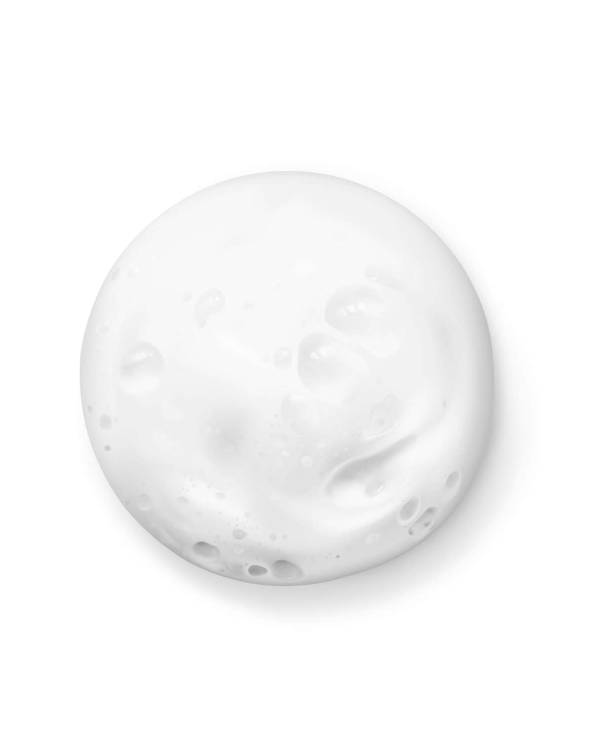 Top-down view of a thick, white dollop of creamy foam cleanser texture on a white background.