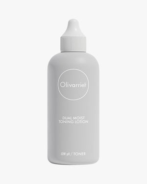 The full 200 ml bottle of Olivarrier Dual Moist Toning Lotion is displayed upright, featuring a light gray, minimalist bottle with a squeeze-top cap and the product name "DUAL MOIST TONING LOTION" clearly printed on the label.