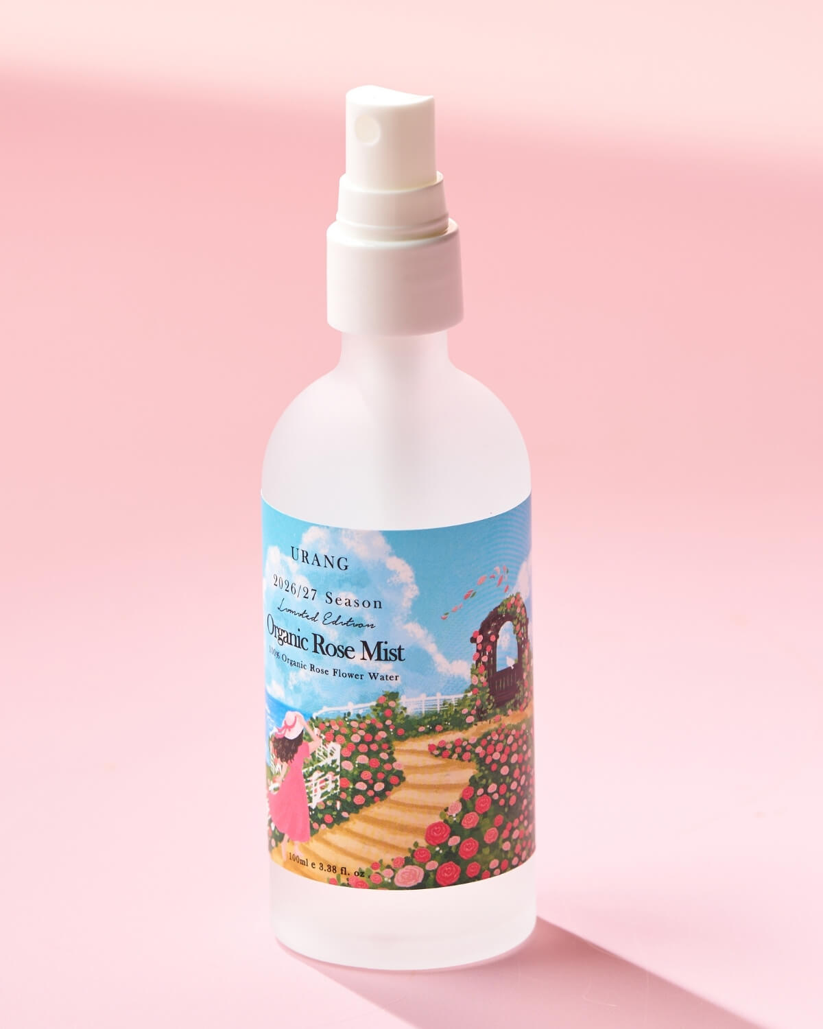URANG Organic Rose Mist 100ml facial spray bottle standing on a soft pink background.