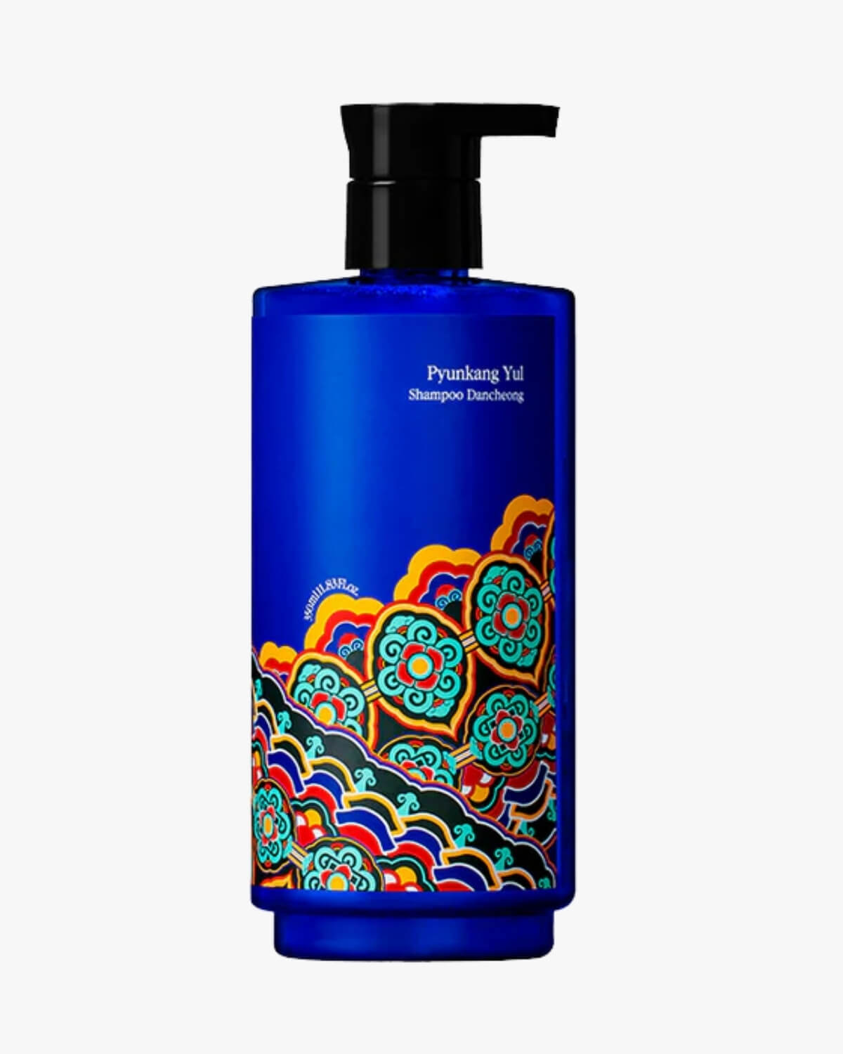 A tall cobalt blue bottle of Pyunkang Yul Shampoo Dancheong with a black pump dispenser and colorful traditional Korean Dancheong patterns on a white background.