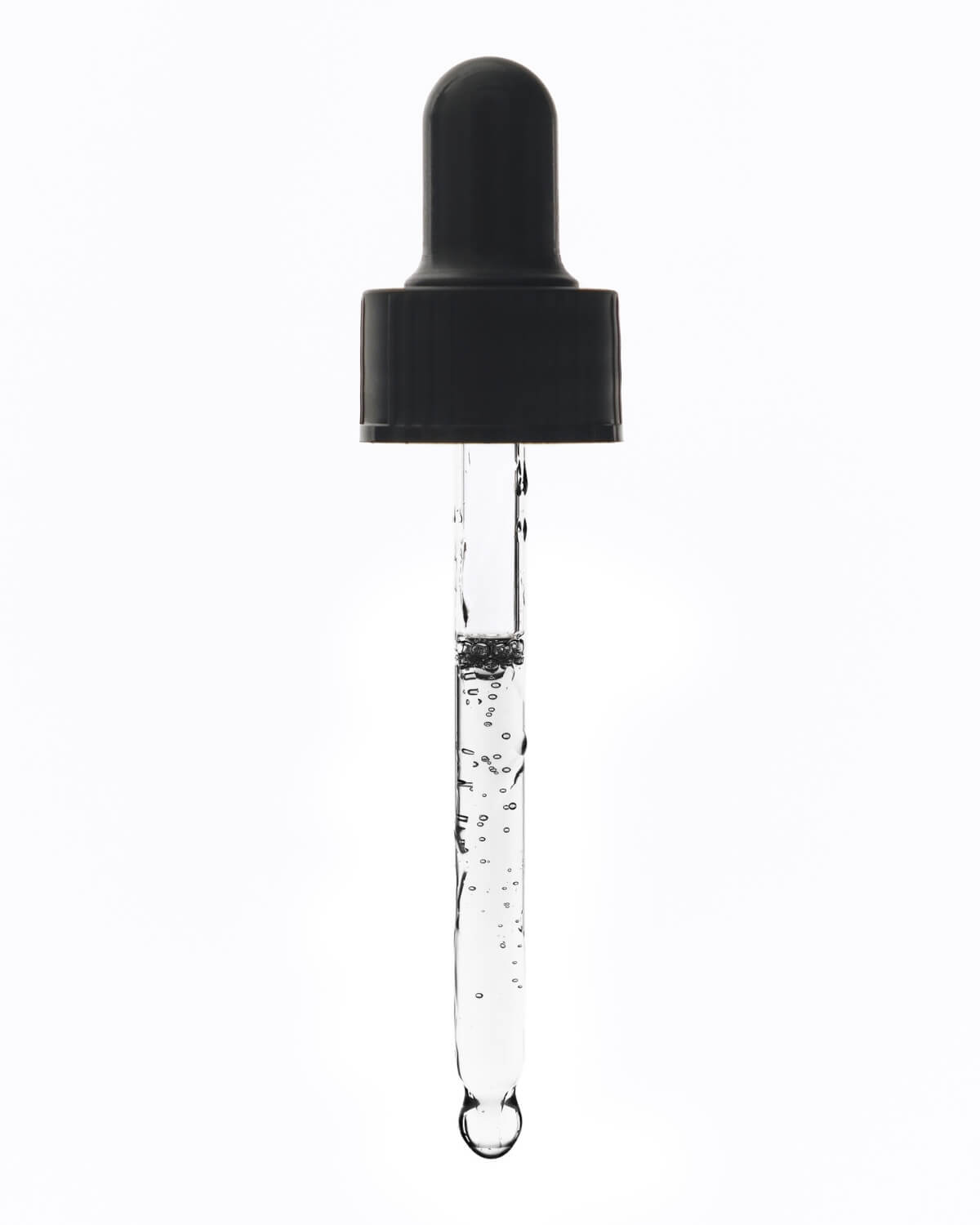 Vertical close-up of the glass pipette from the dropper, filled with the clear, liquid serum and showing small air bubbles suspended within it.