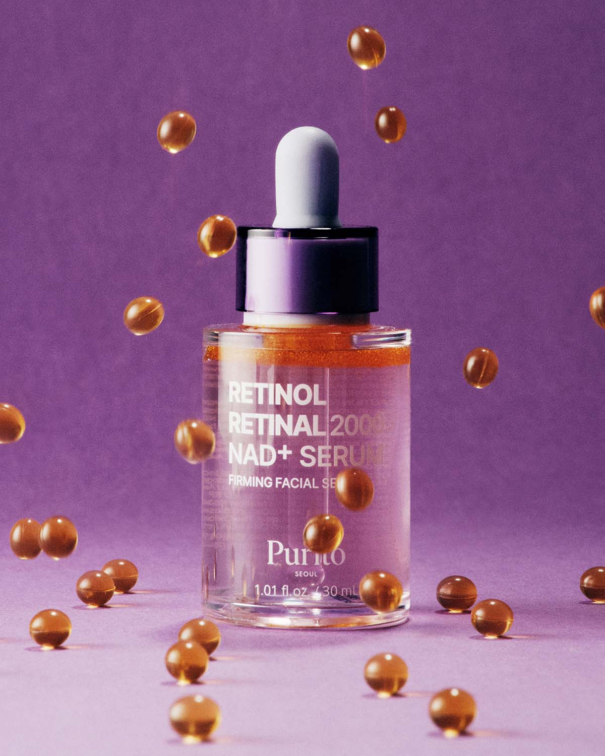 Purito Retinol Retinal 2000 NAD+ Serum bottle surrounded by floating golden oil capsules.