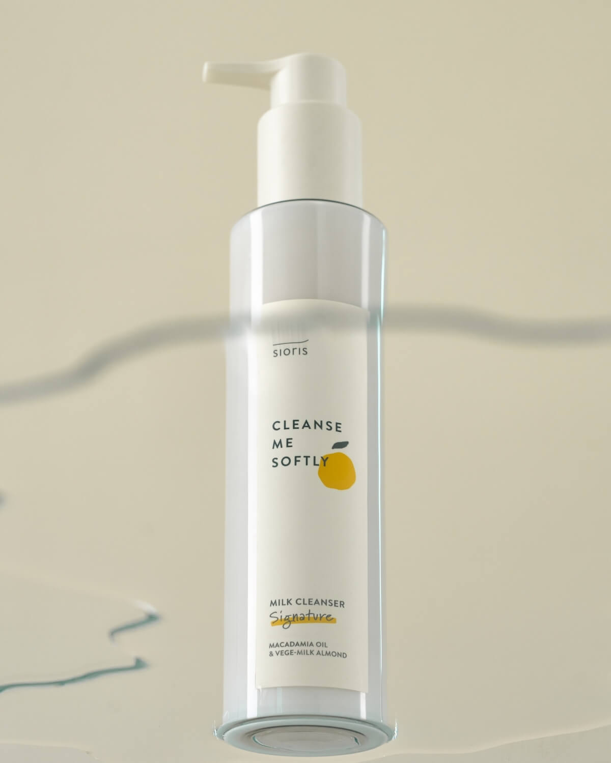 Stylized shot of the Sioris cleanser bottle seen through a blurred glass surface.