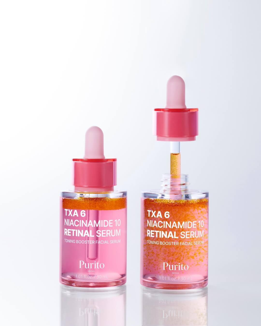 A product comparison shot showing two dropper bottles of Purito TXA 6 Niacinamide 10 Retinal Serum on a reflective white surface. The bottle on the left is closed, while the bottle on the right has the pink dropper cap removed and inserted partially into the serum.