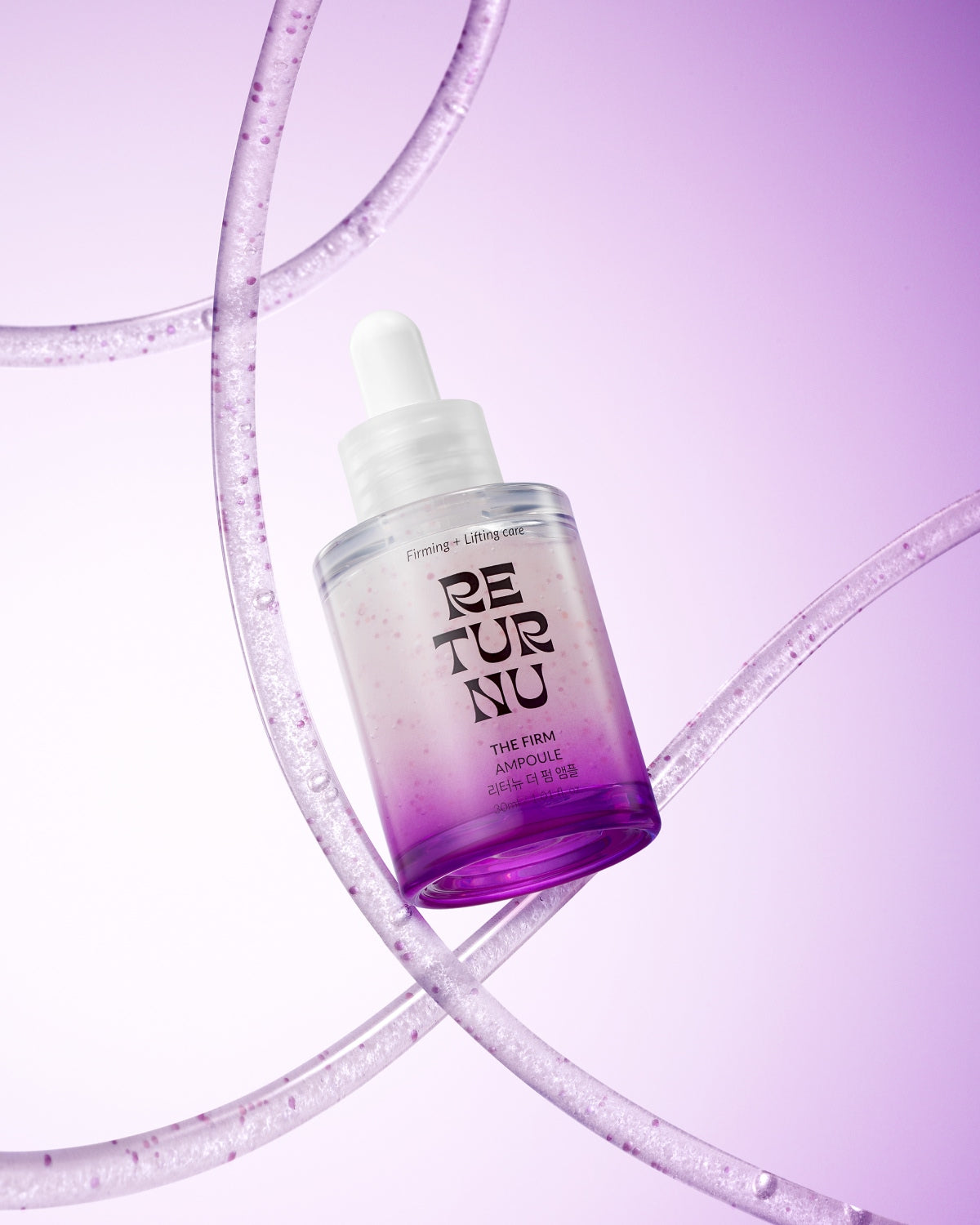The purple gradient ampoule bottle floating diagonally surrounded by clear, bubbling liquid tubes on a light purple background.