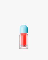 A bottle of Tocobo Juicy Berry Plumping Lip Oil in the bright orange-pink shade 15 Coral Soda.