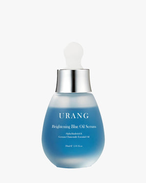 URANG Brightening Blue Oil Serum formulated with Alpha-bisabolol and German Chamomile Essential Oil in a frosted blue glass bottle on a white background.