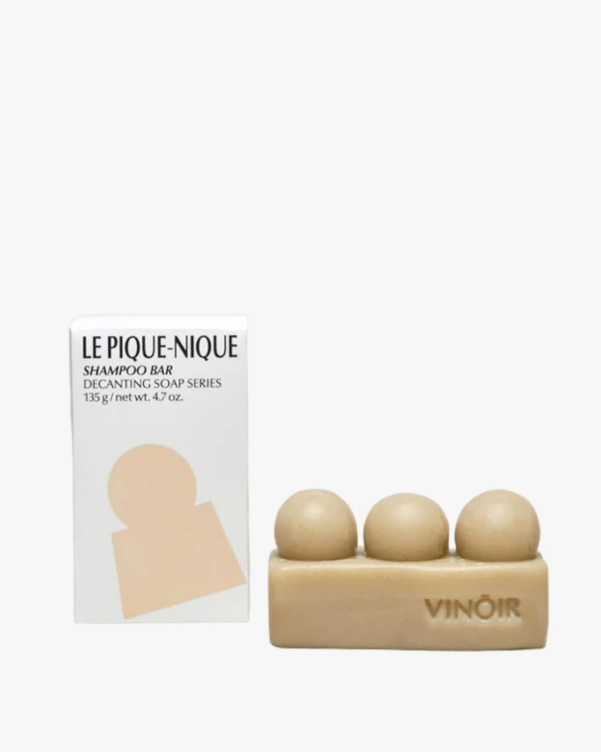 VINŌIR Le Pique-Nique Shampoo Bar in a white background with its tan and white logo box packaging.